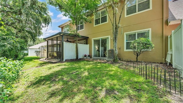 6365 Torrington Cir, Lakeland, FL 33811 - rear view of house featuring a sunroom and stucco siding