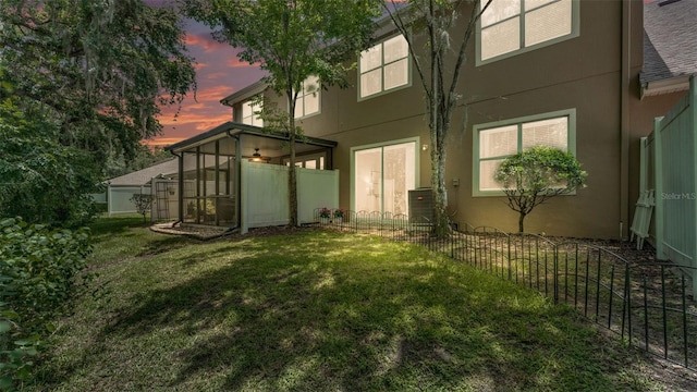 6365 Torrington Cir, Lakeland, FL 33811 - back of house at dusk with stucco siding and a sunroom