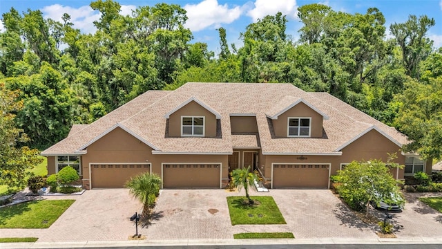 6365 Torrington Cir, Lakeland, FL 33811 - view of front of home with stucco siding, driveway, and stone siding