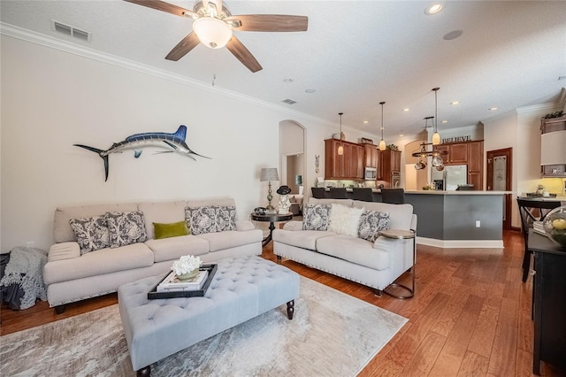 2026 Indian Sky Cir, Lakeland, FL 33813 - living area with a ceiling fan, recessed lighting, wood finished floors, ornamental molding, and arched walkways