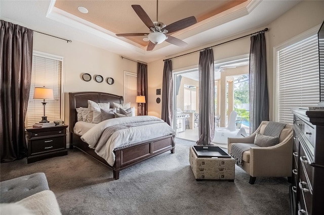 2026 Indian Sky Cir, Lakeland, FL 33813 - bedroom with access to outside, a raised ceiling, carpet, and a ceiling fan