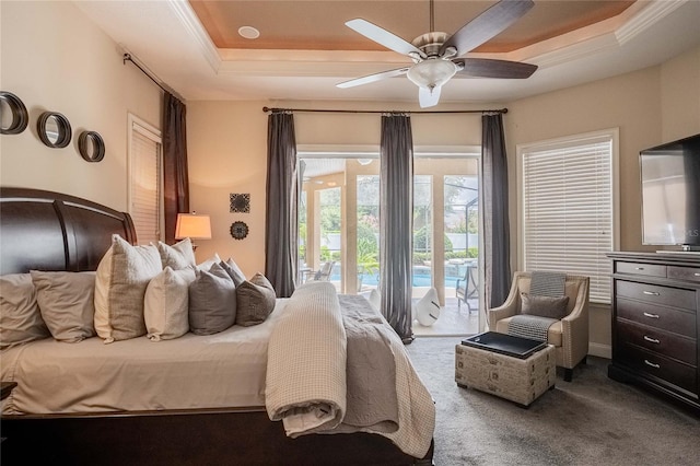 2026 Indian Sky Cir, Lakeland, FL 33813 - bedroom featuring a tray ceiling, carpet flooring, access to exterior, ornamental molding, and a ceiling fan