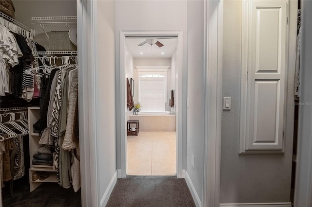 2026 Indian Sky Cir, Lakeland, FL 33813 - walk in closet with dark tile patterned flooring and a ceiling fan