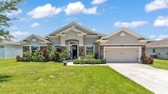1028 15th St NE, Winter Haven, FL 33881 - view of front of home with stucco siding, driveway, stone siding, and an attached garage