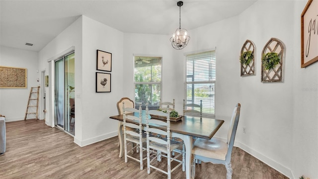 1028 15th St NE, Winter Haven, FL 33881 - dining space with light wood-style floors and a chandelier