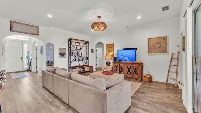 1028 15th St NE, Winter Haven, FL 33881 - living area featuring arched walkways, light wood-style flooring, recessed lighting, and plenty of natural light