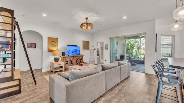 1028 15th St NE, Winter Haven, FL 33881 - living area with light wood-type flooring, recessed lighting, arched walkways, and stairs