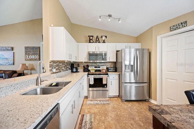1420 Meadows Pond Dr, Bartow, FL 33830 - kitchen featuring appliances with stainless steel finishes, white cabinets, tasteful backsplash, vaulted ceiling, and light stone counters