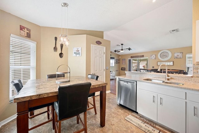 1420 Meadows Pond Dr, Bartow, FL 33830 - kitchen with dishwasher, a ceiling fan, white cabinetry, pendant lighting, and light stone countertops