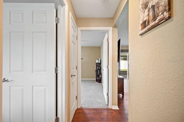 1420 Meadows Pond Dr, Bartow, FL 33830 - corridor with a textured ceiling, wood-type flooring, and a textured wall