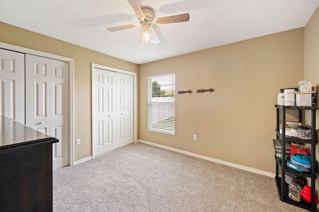 1420 Meadows Pond Dr, Bartow, FL 33830 - carpeted bedroom with multiple closets, a textured ceiling, and a ceiling fan