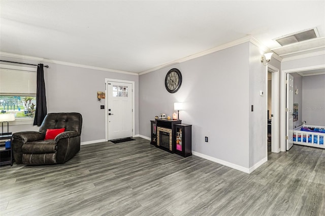 2443 Delrose Dr E, Lakeland, FL 33805 - living room featuring wood finished floors and crown molding