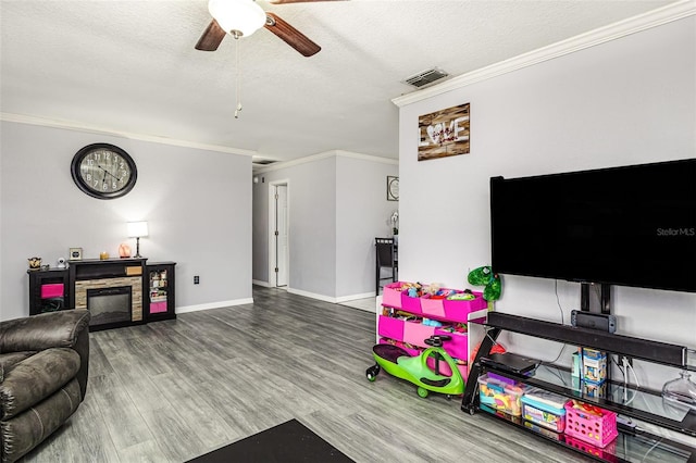 2443 Delrose Dr E, Lakeland, FL 33805 - living room featuring ornamental molding, a ceiling fan, wood finished floors, and a textured ceiling