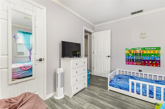 2443 Delrose Dr E, Lakeland, FL 33805 - bedroom featuring ornamental molding and wood finished floors