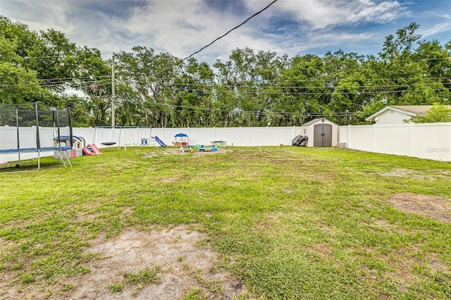 2443 Delrose Dr E, Lakeland, FL 33805 - fenced backyard with a trampoline, a shed, and a playground