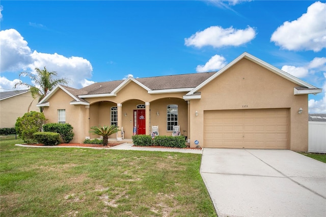 5370 Knights Station Rd, Lakeland, FL 33810 - view of front of house with stucco siding, a garage, and driveway