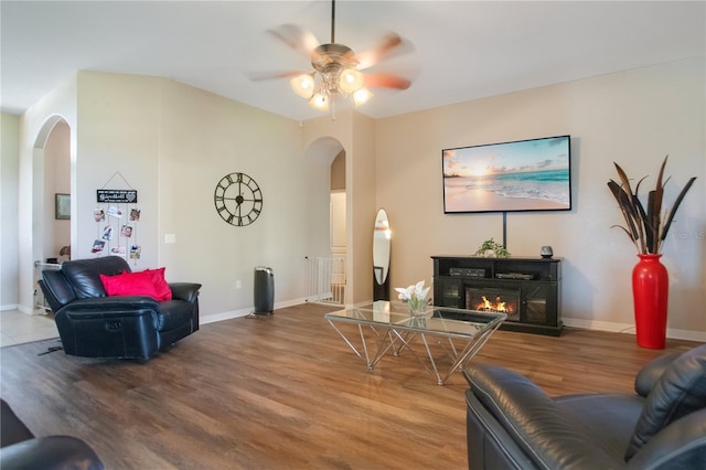 5370 Knights Station Rd, Lakeland, FL 33810 - living area with arched walkways, wood finished floors, and a glass covered fireplace