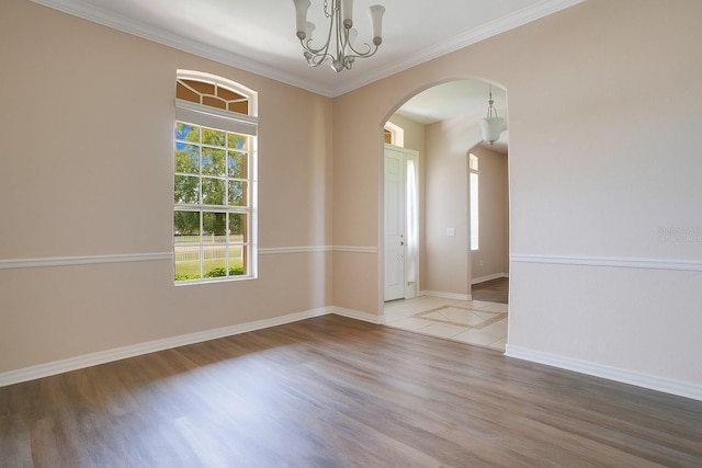 5370 Knights Station Rd, Lakeland, FL 33810 - empty room featuring arched walkways, wood finished floors, crown molding, and a chandelier
