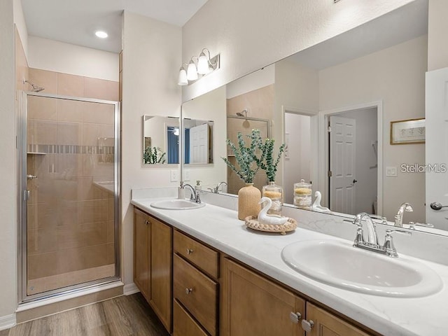 7515 SW 107th Ln, Ocala, FL 34476 - full bathroom featuring double vanity, a shower stall, and wood finished floors