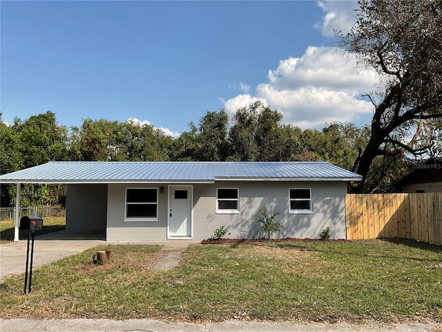 14002 Morgan St, Dade City, FL 33525 - single story home featuring an attached carport, a metal roof, driveway, and concrete block siding