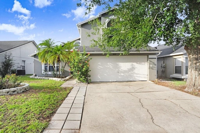 8818 Tottenham Way, Kissimmee, FL 34747 - view of front facade featuring driveway, stucco siding, and a garage