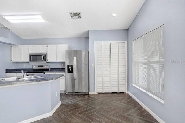 8818 Tottenham Way, Kissimmee, FL 34747 - kitchen with appliances with stainless steel finishes, white cabinetry, dark countertops, and recessed lighting