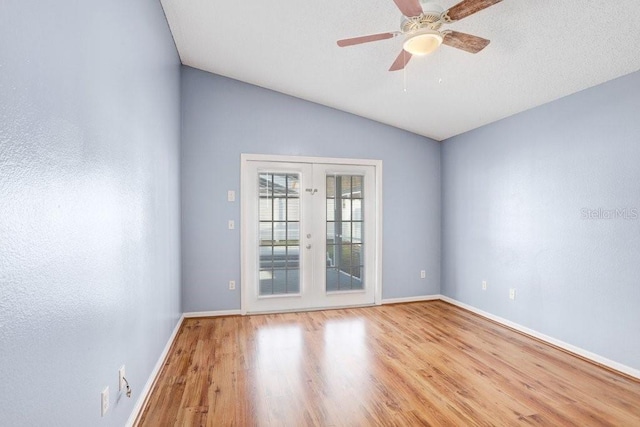 8818 Tottenham Way, Kissimmee, FL 34747 - spare room with french doors, wood finished floors, lofted ceiling, and a ceiling fan