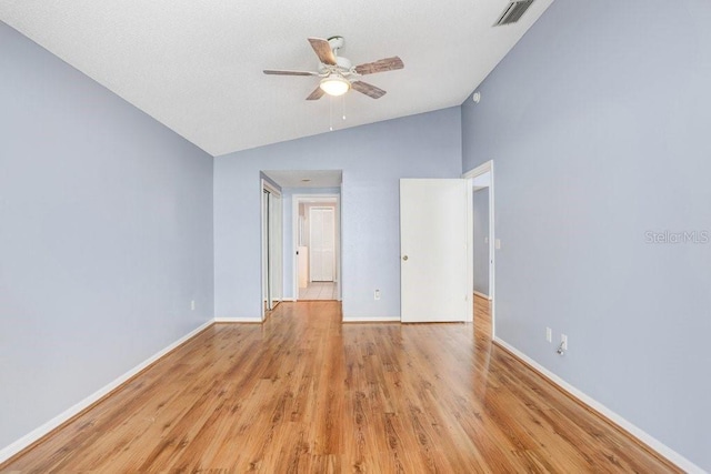 8818 Tottenham Way, Kissimmee, FL 34747 - unfurnished room with lofted ceiling, a ceiling fan, and light wood-style flooring