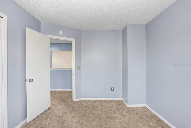 8818 Tottenham Way, Kissimmee, FL 34747 - unfurnished room with carpet floors, a textured ceiling, and a smoke detector