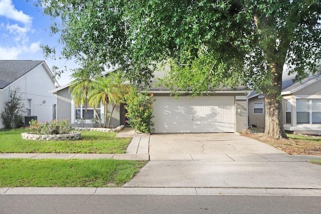 8818 Tottenham Way, Kissimmee, FL 34747 - view of front of home featuring concrete driveway, a garage, and stucco siding