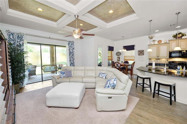 961 Christina Chase Dr, Lakeland, FL 33813 - living room with light wood finished floors, beamed ceiling, coffered ceiling, crown molding, and a ceiling fan