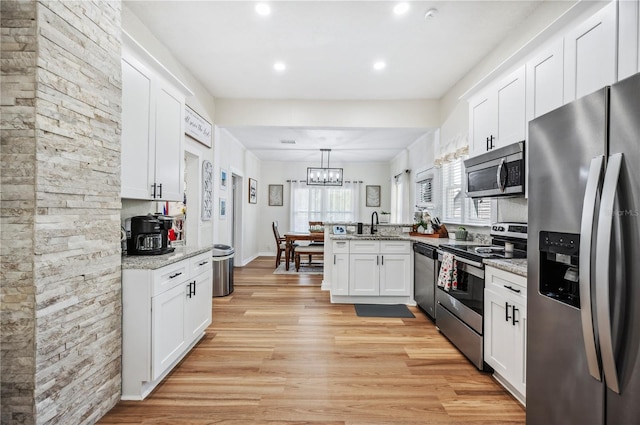 213 Cannon St, Lakeland, FL 33803 - kitchen featuring appliances with stainless steel finishes, a peninsula, white cabinetry, and recessed lighting