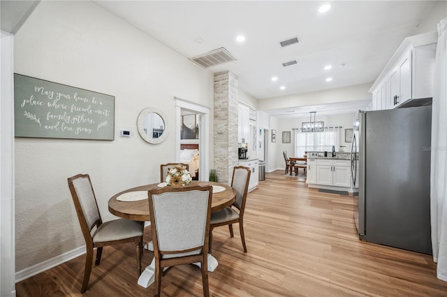 213 Cannon St, Lakeland, FL 33803 - dining room with light wood-style flooring, recessed lighting, and a chandelier
