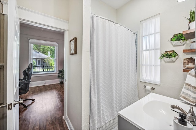 213 Cannon St, Lakeland, FL 33803 - full bathroom featuring wood finished floors and a shower with shower curtain
