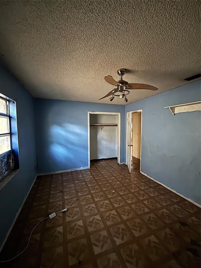 2921 Galaxy Ln, Lakeland, FL 33801 - unfurnished bedroom featuring a textured ceiling, a closet, and ceiling fan