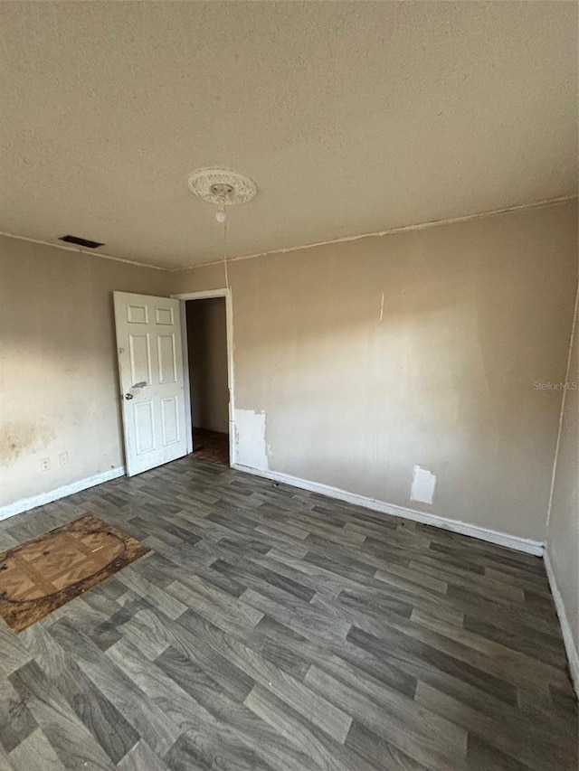 2921 Galaxy Ln, Lakeland, FL 33801 - empty room featuring dark wood finished floors and a textured ceiling