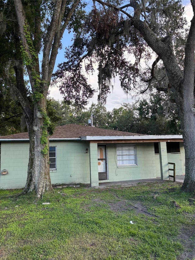 2921 Galaxy Ln, Lakeland, FL 33801 - view of front of home featuring concrete block siding, a front lawn, and a shingled roof