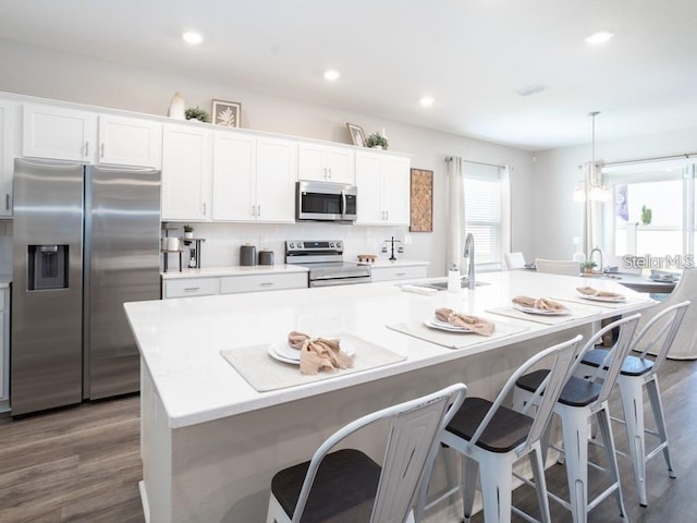 1449 Fleur Dr, Davenport, FL 33837 - kitchen with appliances with stainless steel finishes, white cabinetry, dark wood-type flooring, and recessed lighting