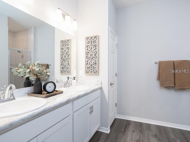 1449 Fleur Dr, Davenport, FL 33837 - full bathroom with double vanity, a stall shower, and wood finished floors