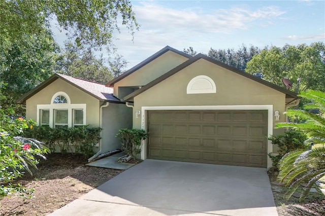 1125 Blackjack Ridge St, Minneola, FL 34715 - ranch-style house featuring an attached garage, stucco siding, and driveway