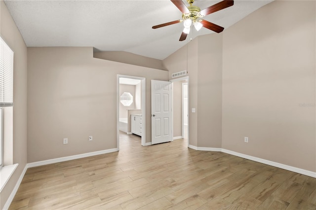 1125 Blackjack Ridge St, Minneola, FL 34715 - unfurnished bedroom with vaulted ceiling, light wood-type flooring, ensuite bath, and ceiling fan