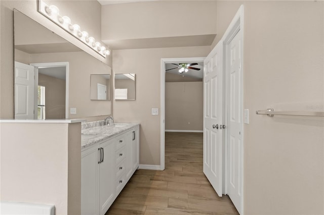 1125 Blackjack Ridge St, Minneola, FL 34715 - bathroom with a ceiling fan, wood finished floors, and double vanity