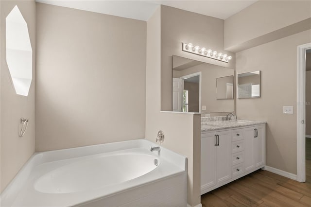 1125 Blackjack Ridge St, Minneola, FL 34715 - full bath featuring double vanity, a bath, and wood finished floors