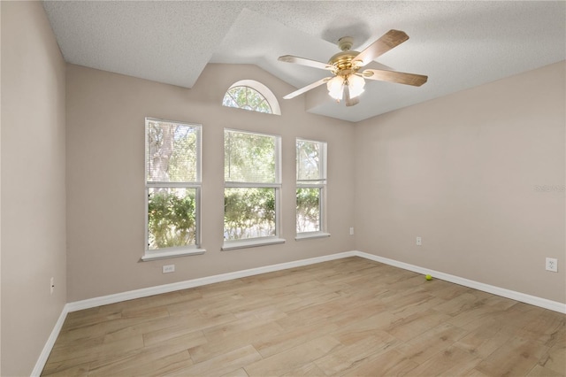 1125 Blackjack Ridge St, Minneola, FL 34715 - spare room featuring light wood-style floors, vaulted ceiling, a ceiling fan, and a textured ceiling