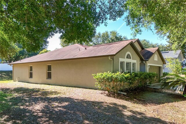 1125 Blackjack Ridge St, Minneola, FL 34715 - view of property exterior featuring stucco siding and an attached garage