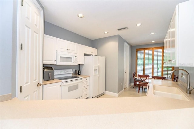 3608 54th Dr W Unit 202, Bradenton, FL 34210 - kitchen featuring white appliances, recessed lighting, white cabinets, and light countertops