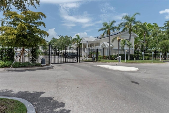 3608 54th Dr W Unit 202, Bradenton, FL 34210 - view of asphalt road with a gate, curbs, and a gated entry