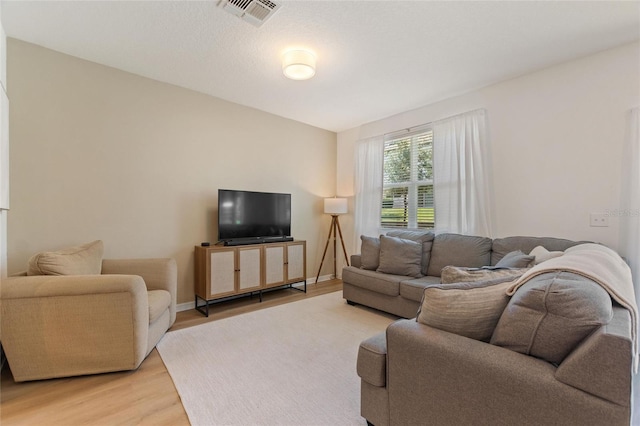 943 Grandin St, Davenport, FL 33837 - living room with light wood-style floors and baseboards