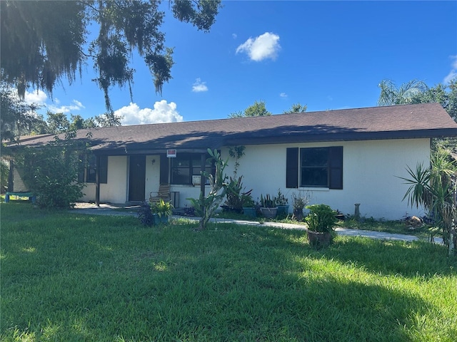 2250 Maple Hill Dr, Lakeland, FL 33811 - single story home featuring stucco siding, a front yard, a porch, and roof with shingles