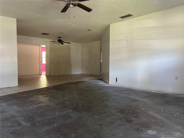 2250 Maple Hill Dr, Lakeland, FL 33811 - unfurnished room with ceiling fan, unfinished concrete flooring, and a textured ceiling